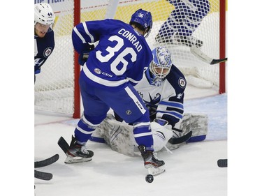 Manitoba Moose Mikhail Berdin G (40) looks for the loose puck past Toronto Marlies Colt Conrad F (36) during the second period in Toronto on Monday March 1, 2021. Jack Boland/Toronto Sun/Postmedia Network