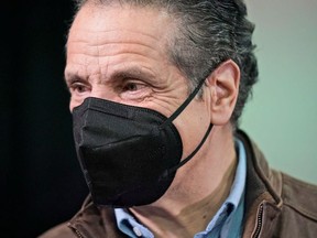 New York Governor Andrew Cuomo talks to people after a press conference before the opening of a mass vaccination site in the Queens borough of New York, U.S., February 24, 2021.