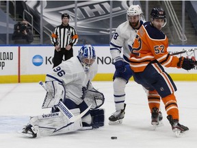 Toronto Maple Leafs' goalie Jack Campbell (36) makes a pad save as the Edmonton Oilers' Patrick Russell (52) battles T.J. Brodie (78) during third period NHL action at Rogers Place, in Edmonton Saturday Feb. 27, 2021.