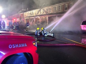 Four people are unaccounted for after a fire broke out at an Oshawa row house Monday morning.
