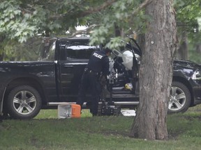 A police examine a pickup truck inside the grounds of Rideau Hall in Ottawa on Thursday, July 2, 2020.