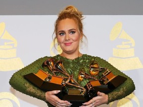 Adele holds the five Grammys she won including Record of the Year for "Hello" and Album of the Year for "25" during the 59th Annual Grammy Awards in Los Angeles, California, U.S. , February 12, 2017.
