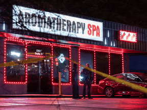 Police at the scene of a massage parlor where a person was shot and killed on March 16, 2021, in Atlanta, Georgia. Seven other people were killed at two other Atlanta spas on the same day.