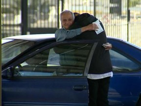 Jose Villarruel hugs former student Steven Nava, after receiving $27,000 as a birthday gift.