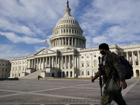A National Guardsman passes the U.S. Capitol on the day the House of Representatives is expected to vote on legislation to provide $1.9 trillion in new coronavirus relief in Washington, U.S., February 26, 2021.