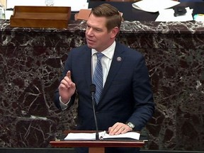U.S. House impeachment manager Rep. Eric Swalwell (D-CA) delivers part of the impeachment managers' opening argument in the impeachment trial of former President Donald Trump on charges of inciting the deadly attack on the U.S. Capitol, on the floor of the Senate chamber on Capitol Hill in Washington, U.S., February 10, 2021.