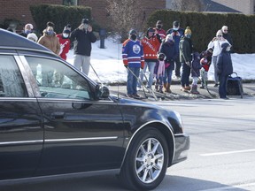 Close to 200 area residents braved the cold and saluted Walter Gretzky with a last stick tap as his hearse exited St. Mark's Anglican Church in Brantford after his funeral on Saturday, March 6, 2021.