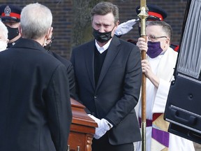 Wayne Gretzky sheds a few tears as the casket containing his father Walter is loaded into the back of a hearse after his funeral at St. Mark's Anglican Church in Brantford on Saturday, March 6, 2021.