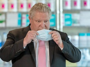 Ontario Premier Doug Ford puts his mask back on after speaking in his daily briefing at Rouge Valley Hospital in Toronto on March 22, 2021.