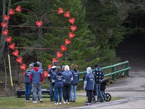 Family and friends of the late Jamie and Greg Blair gather at the Broken Heart Sculpture as they mark the one-year anniversary of the April 2020 murder rampage in rural Nova Scotia, in Truro, N.S. on Sunday, April 18, 2021.