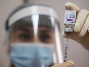 A medical worker fills a syringe with the AstraZeneca vaccine at a hospital in Tbilisi, Georgia March 16, 2021.