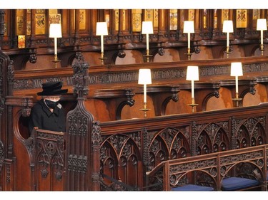 Queen Elizabeth II takes her seat during the funeral of Prince Philip, Duke of Edinburgh, at St George's Chapel at Windsor Castle on April 17, 2021 in Windsor, England.