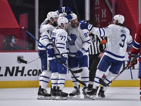 Maple Leafs' Jake Muzzin celebrates his goal with teammates Adam Brooks, Joe Thornton and Justin Holl during the second period against the Montreal Canadiens at the Bell Centre on Wednesday, April 28, 2021 in Montreal, Canada.