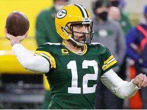Aaron Rodgers of the Green Bay Packers throws a pass in the first half against the Los Angeles Rams during the NFC Divisional Playoff game at Lambeau Field on January 16, 2021 in Green Bay, Wisconsin.
