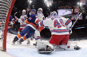 Newly acquired Kyle Plamieri, here buzzing around Rangers goalie Alexandar Georgiev on Friday, would look good on left wing with Mathew Barzal, but is resigned to third-line status on the Islanders for now. (Bruce Bennett/Getty Images)