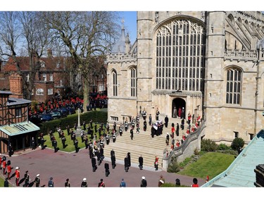 WINDSOR, ENGLAND - APRIL 17: The Duke of Edinburgh's coffin, covered with His Royal Highness's Personal Standard arrives at St George's Chapel carried by a bearer party found by the Royal Marines during the funeral of Prince Philip, Duke of Edinburgh at Windsor Castle on April 17, 2021 in Windsor, England. Prince Philip of Greece and Denmark was born 10 June 1921, in Greece. He served in the British Royal Navy and fought in WWII. He married the then Princess Elizabeth on 20 November 1947 and was created Duke of Edinburgh, Earl of Merioneth, and Baron Greenwich by King VI. He served as Prince Consort to Queen Elizabeth II until his death on April 9 2021, months short of his 100th birthday. His funeral takes place today at Windsor Castle with only 30 guests invited due to Coronavirus pandemic restrictions.