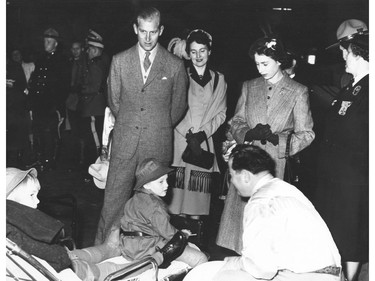 Queen Elizabeth II, then Princess Elizabeth, and her husband Prince Philip, the Duke of Edinburgh speak to unidentified children on a royal visit to Calgary in October 1951.