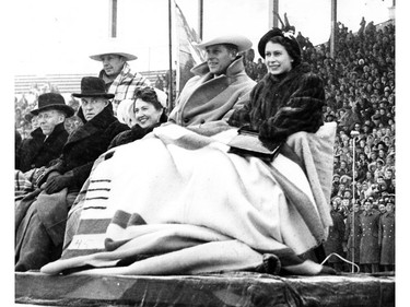 Prince Philip, the Duke of Edinburgh and Queen Elizabeth, then Princess Elizabeth, take in a rodeo on a royal visit to Calgary in October 1951.