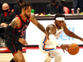 Toronto Raptors guard Gary Trent Jr. and Oklahoma City Thunder forward Luguentz Dort fight for the ball.