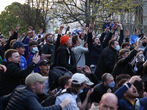 Chelsea fans celebrate outside the stadium before the match after reports suggest they are set to pull out of the European Super League.