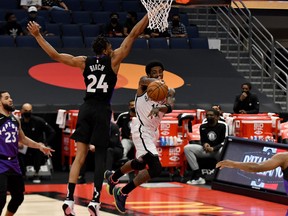 Brooklyn Nets guard Kyrie Irving passes the ball as Toronto Raptors centre Khem Birch defends on Thursday night.