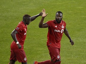 Toronto FC forward Jozy Altidore (right) celebrates with Chris Mavinga during a game last year.