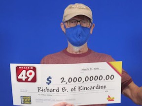 Richard Butler, 77, of Kincardine, holds his $2-million Ontario 49 win.