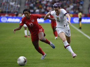 United States forward Megan Rapinoe (15) goes up against Canada defender Ashley Lawrence (10) during the second half of the CONCACAF Women's Olympic Qualifying soccer tournament at Dignity Health Sports Park on Feb. 9, 2020.