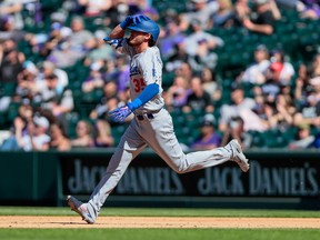 Dodgers' Cody Bellinger watches Rockies outfielder Raimel Tapia catches, then drops the ball over the fence for what would have been a home run on Thursday at Coors Field. A base-running error by Justin Turner negated the two-run blast.