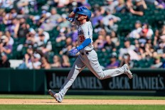 Dodgers' Cody Bellinger watches Rockies outfielder Raimel Tapia catches, then drops the ball over the fence for what would have been a home run on Thursday at Coors Field. A base-running error by Justin Turner negated the two-run blast.