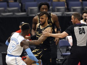Lakers guard Dennis Schroder (17) and Toronto Raptors guard Gary Trent Jr. (33) push each other as Schroder gets ejected on Tuesday night.