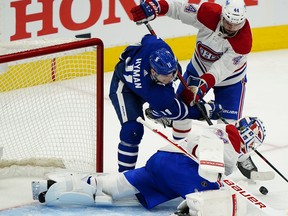 Montreal Canadiens goaltender Jake Allen (34) battles with Toronto Maple Leafs forward Zach Hyman on Wednesday night.