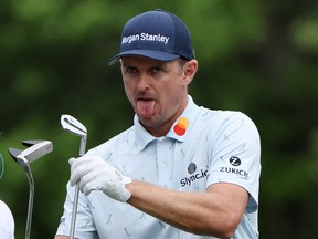 Justin Rose reacts after making a shot during the first round at the Masters in Augusta, Ga., yesterday. Rose (-7)  was four shots better than the next best score.