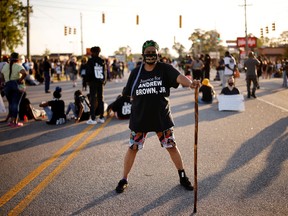 A protester stands guard as demonstrators occupy a busy intersection a week after Andrew Brown Jr. was killed by sheriff’s deputies in Elizabeth City, North Carolina, April 28, 2021.