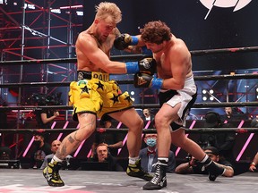 Ben Askren punches Jake Paul in their cruiserweight bout during Triller Fight Club at Mercedes-Benz Stadium on April 17, 2021 in Atlanta.