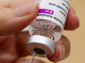 A medical worker prepares a dose of Oxford/AstraZeneca's COVID-19 vaccine at a vaccination centre in Antwerp, Belgium, March 18, 2021.