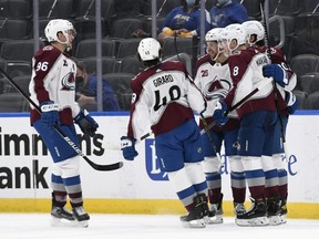 Avalanche left wing Brandon Saad (20) is congratulated by teammates after scoring a goal during the second period against the Blues at Enterprise Center in St.Louis, Wednesday, April 14, 2021.