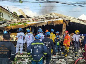 This handout from the Poh Teck Tung Foundation taken and released on April 3, 2021 shows rescue workers at the site of a building collapse in Bangkok.
