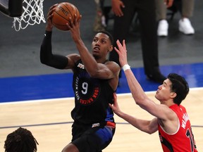New York Knicks guard RJ Barrett (9) drives to the basket against Toronto Raptors forward Yuta Watanabe (18) during the second half of an NBA basketball game Saturday, April 24,2021, in New York.