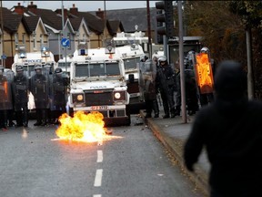 A fire burns in front of the police on the Springfield Road as protests continue in Belfast, Northern Ireland April 8, 2021.