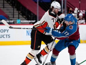 Brockville-born Ben Hutton (left) pushes Tyson Jost off the puck during an Anaheim-Colorado game in Denver. The Maple Leafs acquired Hutton, a defenceman, on Monday, April 12, 2021.