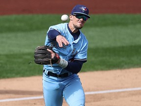 Cavan Biggio of the Toronto Blue Jays, a standout defensively at third on opening day, guns out a New York base-runner at Yankee Stadium on April 1, 2021.