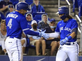 Bo Bichette of the Toronto Blue Jays celebrates his home run in the third inning with George Springer at TD Ballpark on April 30, 2021 in Dunedin, Florida.