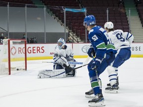 Canucks forward Bo Horvat (53) scores the winning goal in overtime against Toronto Maple Leafs goalie Jack Campbell, who has now lost three in a row after winning 11 straight, in Vancouver on Sunday night.