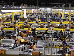 People work inside the Amazon fulfillment centre in Brampton on Friday, July 21, 2017.