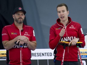 Team Canada skip Brendan Bottcher of Edmonton (right) and third Darren Moulding go over their options during Draw 7 against Team Switzerland.