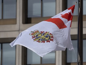 The Canadian Forces flag flies outside office buildings in Ottawa, Tuesday March 9, 2021.