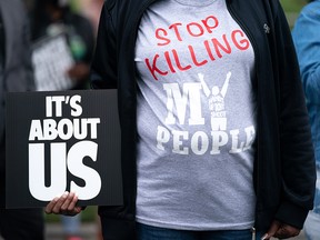 A demonstrator holds a sign during a protest march calling for the release of police body camera footage from the shooting death of Andrew Brown Jr. on April 24, 2021 in Elizabeth City, North Carolina.