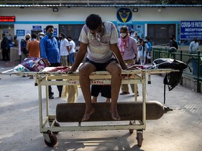 A patient suffering from the coronavirus disease (COVID-19) waits to get admitted outside the Guru Teg Bahadur hospital in New Delhi, India, April 23, 2021.