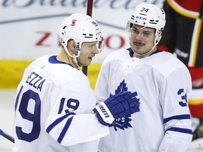 Toronto Maple Leafs' Auston Matthews, right, celebrates his goal with teammate Jason Spezza during third period NHL hockey action against the Calgary Flames in Calgary, Sunday, Jan. 24, 2021.